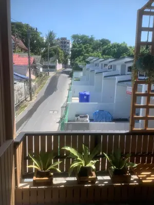 a balcony with a view of a street at Nai Yang Guest House in Nai Yang Beach