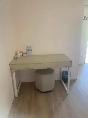 a wooden desk with a trash can under it at Nai Yang Guest House in Nai Yang Beach