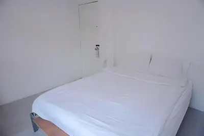a white bed in a white room at XX Bao Patong Beach - เบา ป่าตอง ภูเก็ต in Patong Beach