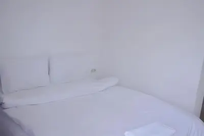 a white bed with a light on top of it at XX Bao Patong Beach - เบา ป่าตอง ภูเก็ต in Patong Beach