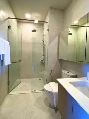 a bathroom with a shower and a toilet and a sink at New 2 Br Apartment Cherng talay in Laguna Phuket