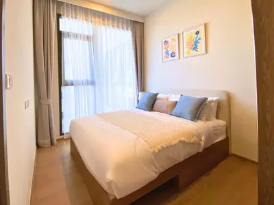 a bedroom with a large bed with a window at New 2 Br Apartment Cherng talay in Laguna Phuket