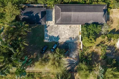 an overhead view of a house with a pool and palm trees at Peaceful Retreat at Villa Langkah Luan, Mai Khao in Mai Khao Beach