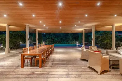 a dining room with a long table and chairs at Peaceful Retreat at Villa Langkah Luan, Mai Khao in Mai Khao Beach