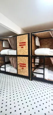 two bunk beds in a room with a floor at Sleep On The Clouds in Ban Kata