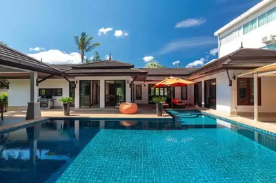 a swimming pool in front of a house at Sea Breeze Pool Villa on Quiet Kamala Cul de sac in Kamala Beach