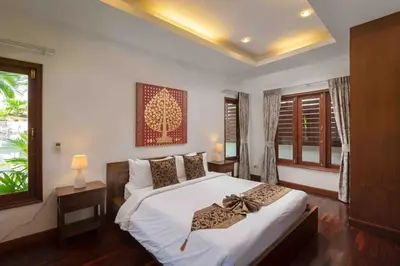 a bedroom with a large white bed and a window at Sea Breeze Pool Villa on Quiet Kamala Cul de sac in Kamala Beach