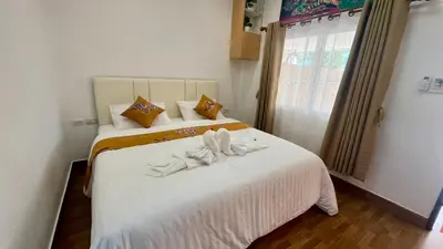 a bedroom with two beds with white towels on them at Vida House Krabi, Ao Nang Beach in Ban Khlong Haeng