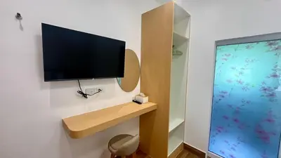 a room with a tv on a wall with a toilet at Vida House Krabi, Ao Nang Beach in Ban Khlong Haeng