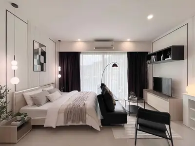 a bedroom with a large bed and a television at CHIC CONDO - Cozy studio with mountain and sea views in Karon Beach