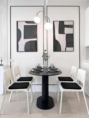 a dining room with a black table and white chairs at CHIC CONDO - Cozy studio with mountain and sea views in Karon Beach