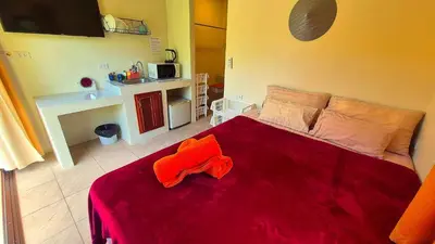a bedroom with a large red bed in a room at Jasmine Seaview 'B' Friendly Guest House in Ban Saiyuan (1)