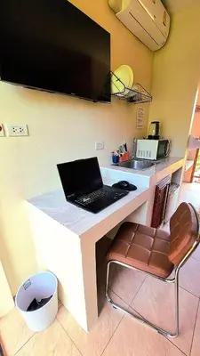 a laptop computer sitting on a counter in a kitchen at Jasmine Seaview 'B' Friendly Guest House in Ban Saiyuan (1)