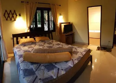 a bedroom with a large bed in a room at Jasmine's Bungalow 3 bedroom 2 bathrooms Baby Cots in Ban Saiyuan (1)