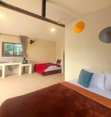 a bedroom with a bed and a desk and a sink at Jasmine Ocean View Penthouse in Ban Saiyuan (1)