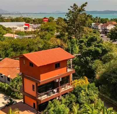 an orange house with an orange roof at Jasmine Seaview 'A1' Friendly Guesthouse in Ban Saiyuan (1)