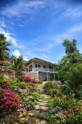 a house with a garden of flowers in front of it at Villakrabi center in Klong Muang Beach