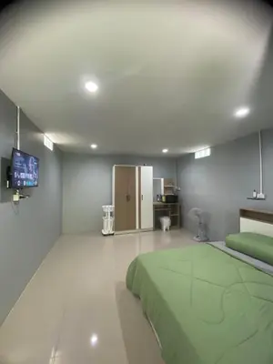 a bedroom with a bed and a flat screen tv at Villakrabi center in Klong Muang Beach
