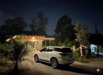 a white suv parked in front of a house at night at Villakrabi center in Klong Muang Beach