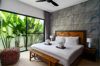 a bedroom with a bed and a large window at Alex Villa by G Estate Phuket in Ban Saiyuan (1)