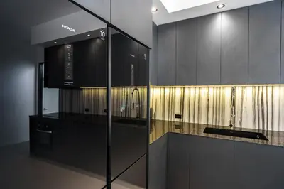 a kitchen with black and gold cabinets and a counter at Alex Villa by G Estate Phuket in Ban Saiyuan (1)