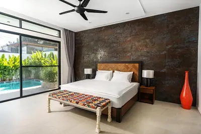 a bedroom with a bed and a large window at Alex Villa by G Estate Phuket in Ban Saiyuan (1)