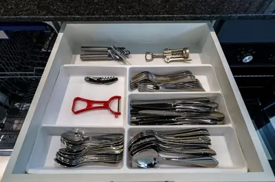 a drawer full of silverware with a red pair of scissors at Alex Villa by G Estate Phuket in Ban Saiyuan (1)