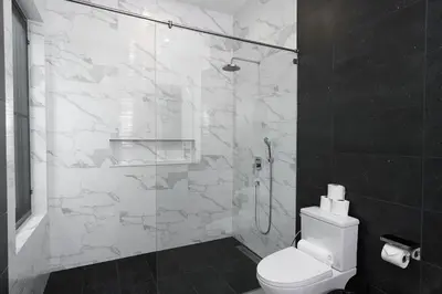a bathroom with a toilet and a glass shower at Alex Villa by G Estate Phuket in Ban Saiyuan (1)