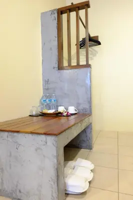 a table in a room with some water bottles and towels at The Meeting House Aonang - self service in Ao Nang Beach