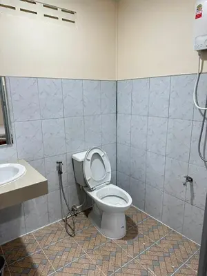 a bathroom with a toilet and a sink at Happy Koh Yao Yai Bangkalo in Ban Tha Rua