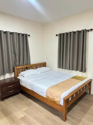 a bedroom with a large bed and curtains at Happy Koh Yao Yai Bangkalo in Ban Tha Rua