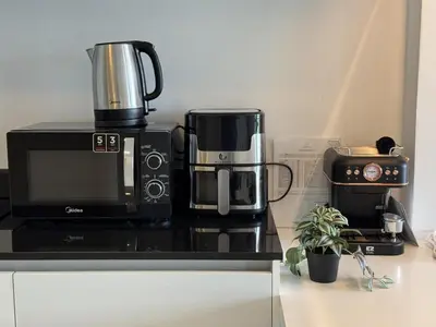 a microwave and a coffee maker on a counter at A Taste of Utopia -Modern Phuket Retreat with Jacuzzi in Karon Beach