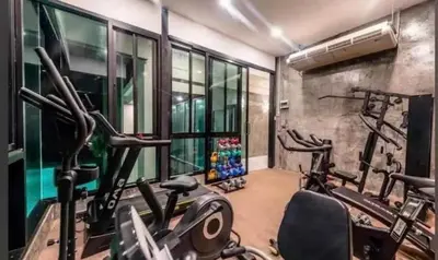 a gym with two treadmills and two exercise bikes at The Viva Patong Condo in Patong Beach