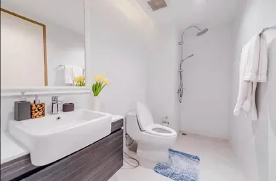 a white bathroom with a sink and a toilet at The Viva Patong Condo in Patong Beach