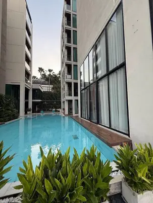 a large swimming pool next to a building at The Viva Patong Condo in Patong Beach