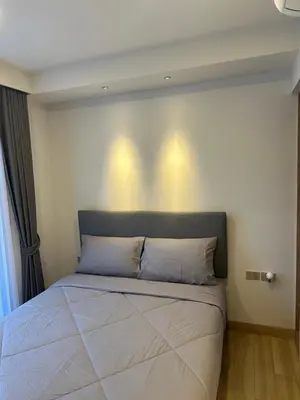 a bed in a bedroom with lights on the wall at Laguna SkyPark in Laguna Phuket
