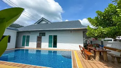 a pool in front of a house with a table and chairs at Soulful Stay Phuket l Phanason Park Ville 1 Near Kathu Waterfall in Ban Kathu
