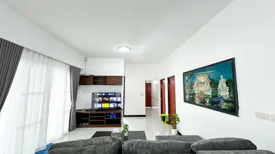 a living room with a couch and a tv at Soulful Stay Phuket l Phanason Park Ville 1 Near Kathu Waterfall in Ban Kathu