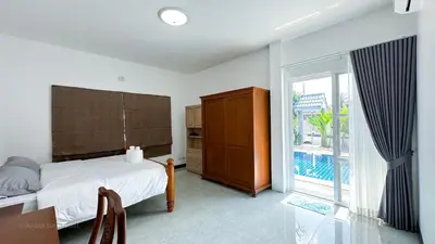 a bedroom with a bed and a large window at Soulful Stay Phuket l Phanason Park Ville 1 Near Kathu Waterfall in Ban Kathu