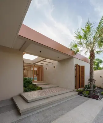 a house with a palm tree in front of it at Celestia Villas - Pool villa 4BR near Boat Avenue in Ban Pak Lak