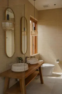 a bathroom with a sink and a toilet and two mirrors at Celestia Villas - Pool villa 4BR near Boat Avenue in Ban Pak Lak