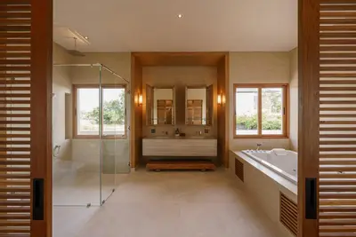 a bathroom with a shower and a tub and a sink at Celestia Villas - Pool villa 4BR near Boat Avenue in Ban Pak Lak