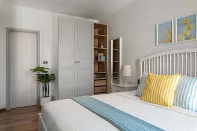 a bedroom with a white bed with a yellow pillow at Title Halo Lemon Sky Naiyang Gym Pool Hammam in Ban Bo Han