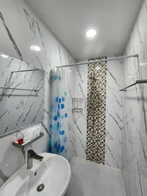 a white bathroom with a shower and a sink at Raya villa in Ban Muang Mai