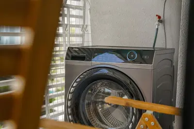 a washing machine in a room with a window at Title Halo Pinky Lime Naiyang Pool Gym Hammam in Ban Bo Han