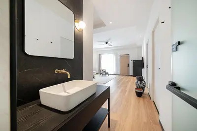 a bathroom with a white sink on a counter at wolin patong greeen resort in Patong Beach