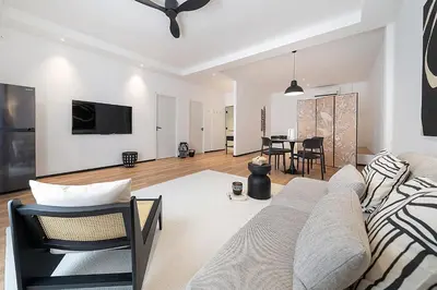a living room with a couch and a table at wolin patong greeen resort in Patong Beach