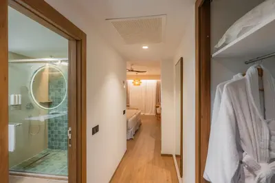 a bathroom with a walk in shower and a glass door at Hotel Riu Palace Phuket - All Inclusive in Mai Khao Beach