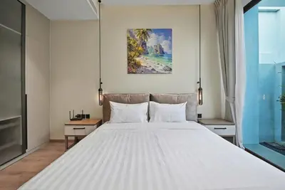 a large white bed in a room with a window at C32 Clover Residence Villa Phuket 3 bd in Ban Thalat Choeng Thale