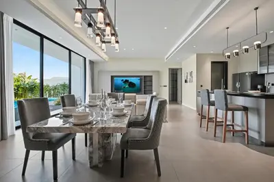 a dining room and kitchen with a table and chairs at C32 Clover Residence Villa Phuket 3 bd in Ban Thalat Choeng Thale